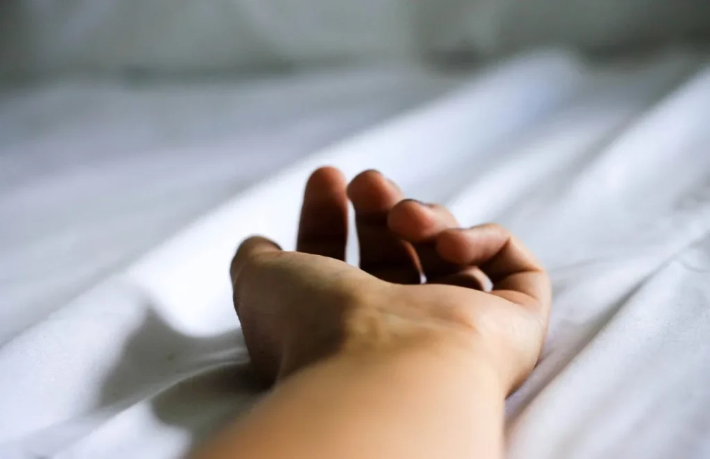 Masaje erótico en Barcelona | Masajistas tántricas | Bliss Barcelona | Blog | beneficios Mano descansando sobre sábanas blancas tras un masaje erótico terapéutico | Foto #4